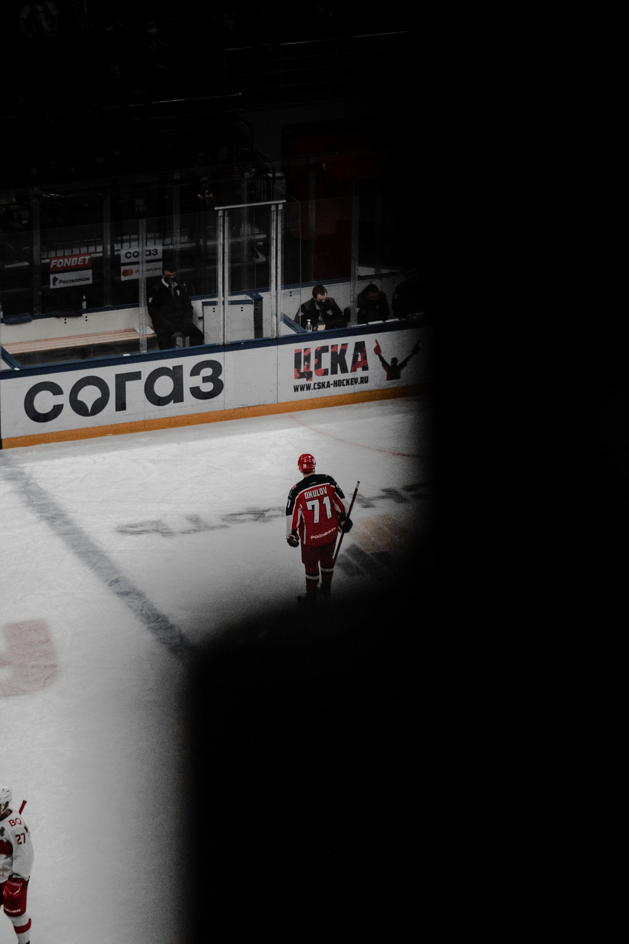 man in red jacket riding on red and white ice hockey field